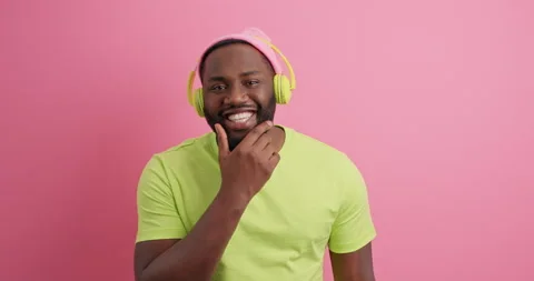 Happy bearded dark skinned man holds chin stares surprisingly at camera has good Stock Footage 150298043