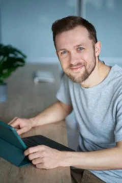 Happy bearded freelance software developer working in working place at office 스톡 사진