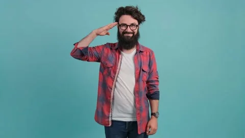 Happy bearded guy saluting with hand, saying yes sir, on turquoise background. Stock Footage 143268855