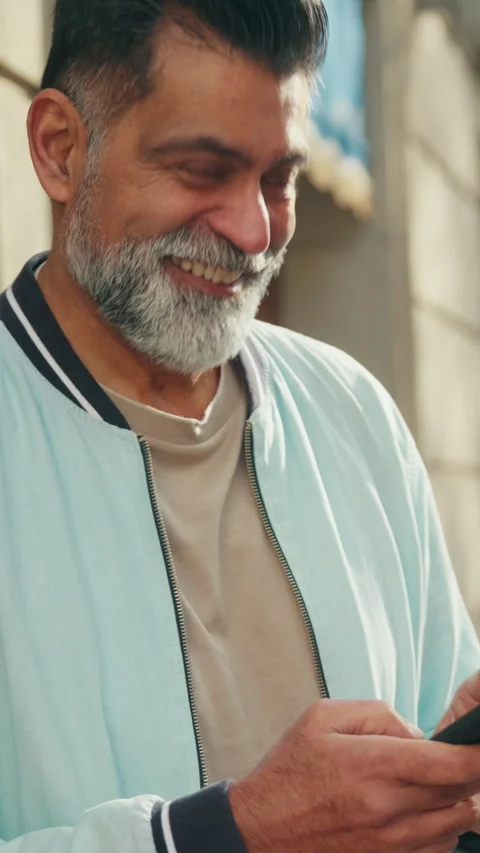 Happy Bearded Indian Man Uses Phone on City Street Stock Footage 331751968