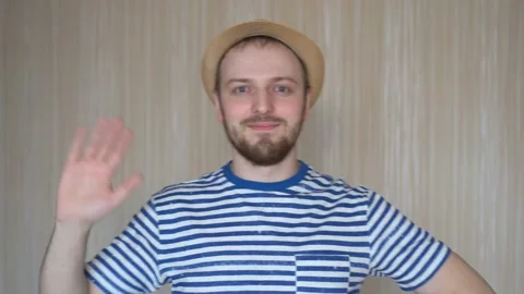 Happy bearded man in hat waving with his hand Stock Footage 103132398