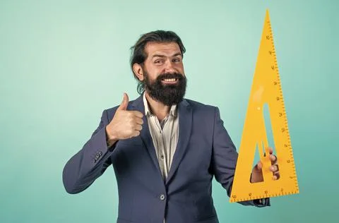 Happy bearded man hold math tool triangle ruler, calculation and search of 写真素材