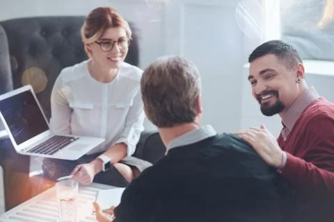 Happy bearded man looking at his colleague Stock Photos
