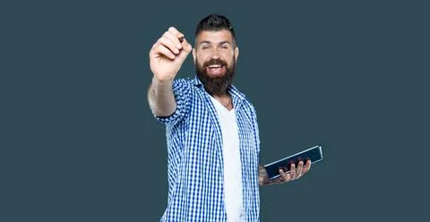 Happy bearded man making notes in book point on you Stock Photos