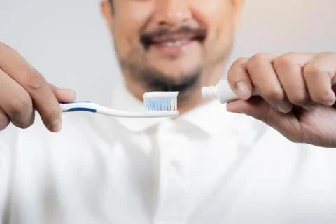 Happy bearded man putting toothpaste on a toothbrush bathroom. Personal hyg.. Foto stock