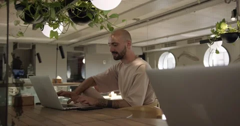 Happy bearded man using laptop for remote work at cafe Stock Footage 159083609