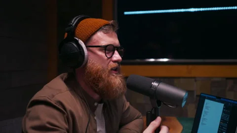 Happy bearded presenter interviewing guest in recording studio Stock Footage 269069202