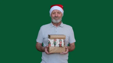 Happy beared senior man looking at camera , holding christmas gifts and smiling Stock Footage 145741078