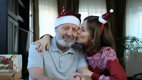Happy beared senior man in red christmas hat with adult daughter, celebrating ne Video stock 144969239