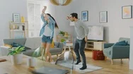 Happy Beautiful Couple Is Having Fun And Actively Dancing In Their Living Room Stock Footage