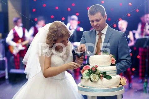 Happy Beautiful Newlyweds Taste Cake In Restaurant