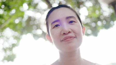 Happy Beautiful smiling middle-aged Asian woman in the morning garden. Take care Video stock 145940681