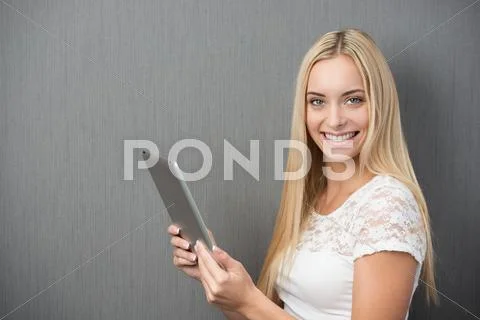 Happy beautiful woman with a tablet-pc Stock Photos