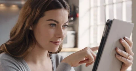 Happy beautiful woman using digital tablet browsing the internet staying Stock Footage 56949541
