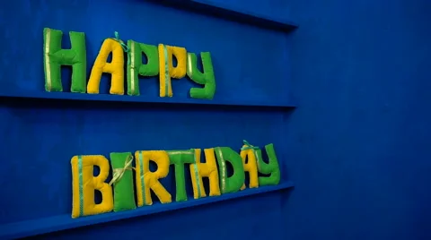 Happy Birthday from felt letters on blue background Stock Footage