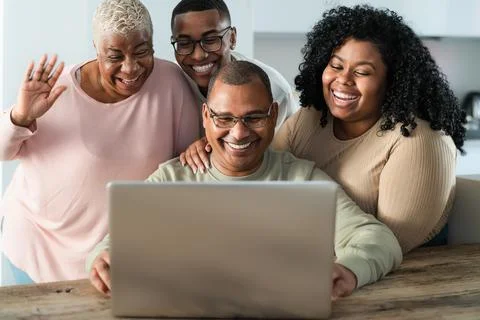 Happy black family having fun doing video call using laptop at home Stock Photos