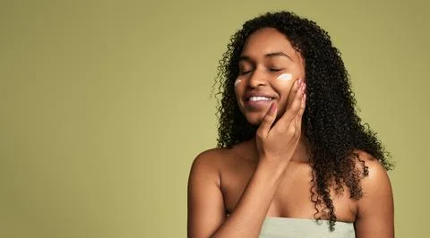 Happy black lady smiling while enjoying self care routine after bath Stock Photos
