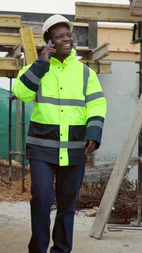 Happy, black man and engineer at site with phone call, inspection and ideas for Stock Footage 338011199