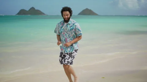 Happy Black Man Dancing on White Sandy Beach with Crystal Clear Turquoise Waters Stock Footage 274531037