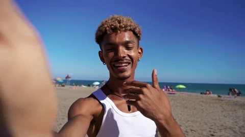 Happy black man talking using smartphone to do video call while enjoying the Stock Footage 276621714