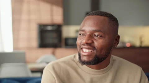 Happy Black man thinking or day dreaming at home Stock Footage 162139645
