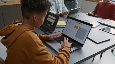 Happy Black Schoolboy Working with AI Generator and Chatting to Classmates Stock Footage 318714265