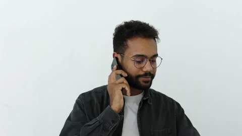 Happy black skinned man grey shirt with curly hair and eyewear talk mobile phone Stock Footage 196127366