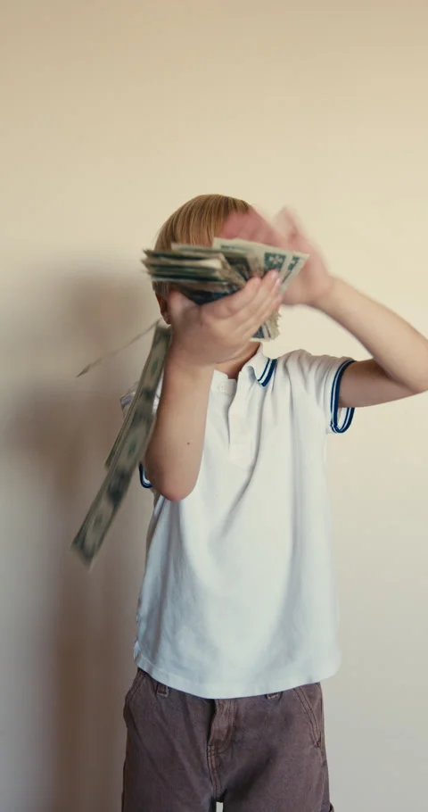 Happy blond boy throwing dollar bills Stock-Footage 346983496