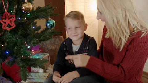 Happy blond mother with her son under a christmas tree Stock Footage