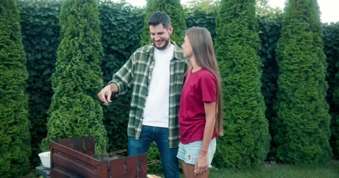 Happy blonde girl posing while communicating with her brunette boyfriend with a Stock Footage 283832510