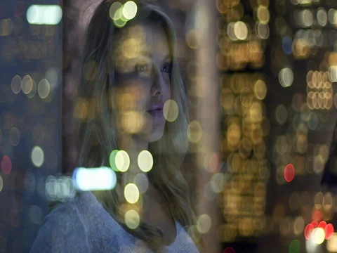 Happy blonde reflected in window overlooking nighttime LA 4K Stock Footage 73103336