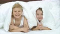 The happy boy and a girl laying under the bed 4k or 4k+ Resolution