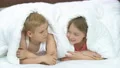 The happy boy and a girl laying under the bed 4k or 4k+ Resolution