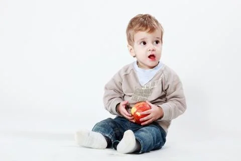 Happy boy with apple Stock Photos