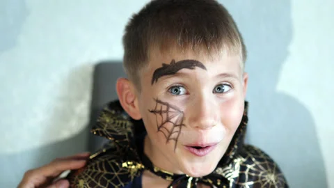 Happy boy because of his cool art on face for Halloween party. Stock Footage 158803925