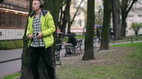 Happy boy dancing and singing in the park Stock Footage 49473603