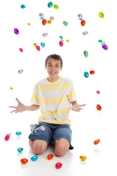 Happy boy with easter eggs falling Stock Photos