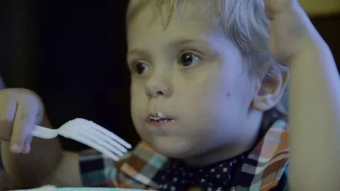 Happy boy eats cake on his birthday 4k Video stock 78492016