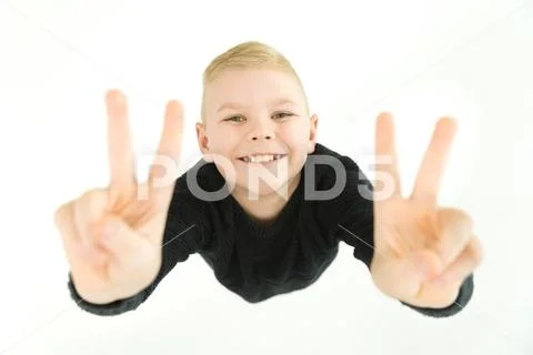 The happy boy gesture to the camera. View from above Stock Photos