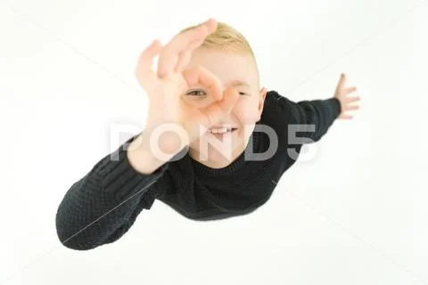 The happy boy gesture to the camera. View from above Stock Photos