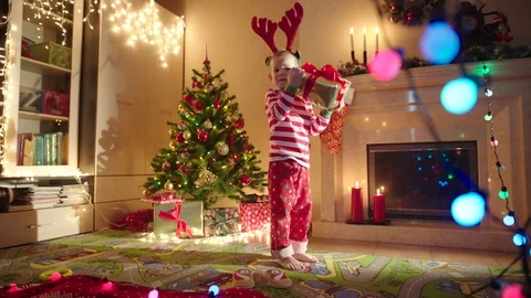 Happy boy with gift box on New Years night Stock Footage 72983166