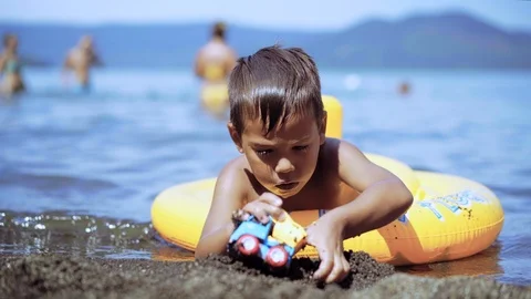 Happy boy having fun playing on vacation in water on the Sea. Cute kid playing Stock-Footage 93361123