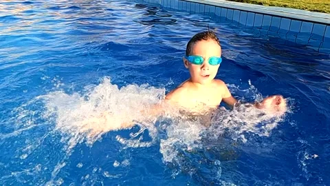 Happy boy having fun in the pool, create... | Stock Video | Pond5