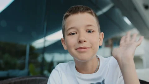 Happy boy having video chat using mobile phone camera Stock Footage 104441077