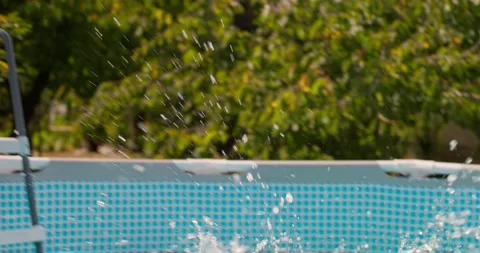Happy boy with inflatable ring jumps in the pool, enjoys swimming in the pool Vidéo 261145985
