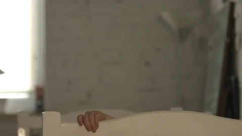 Happy boy jumping in a crib and clapping. 库存影片 74771834