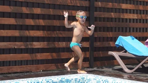 Happy Boy Jumping into the Pool with Blue Water. Stock Footage 122224553