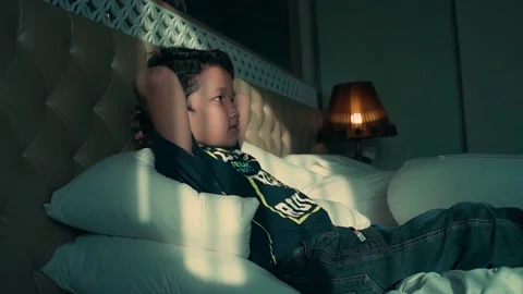 Happy boy lying in bed Stock Footage 210532320