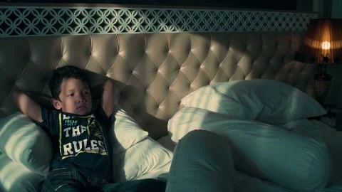 Happy boy lying in bed Stock Footage 210532607