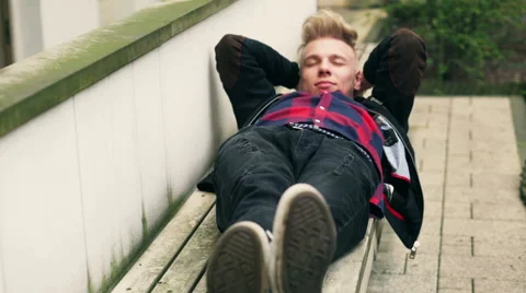 Happy boy lying on the bench and relaxing Stock-Footage 50572021
